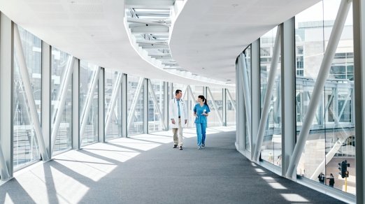 picture of two people walking in hospital hallway