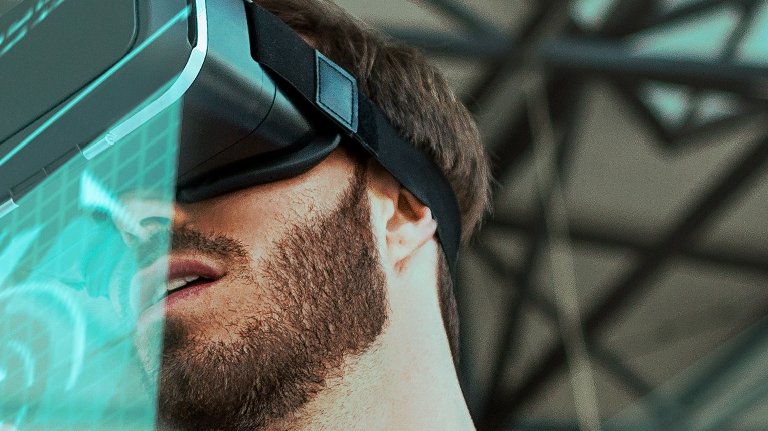 image of man wearing VR goggles in corporate office