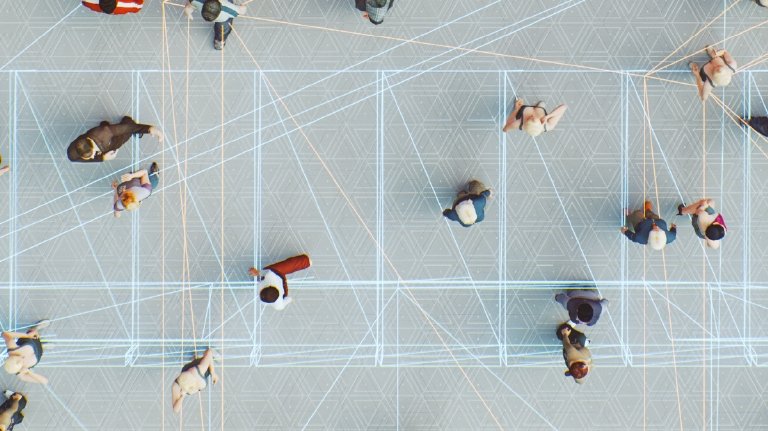 image of a group of people from birds eye view connected with digital lines (metaphor for the Metaverse — playing on a digital world and inter connectivity)