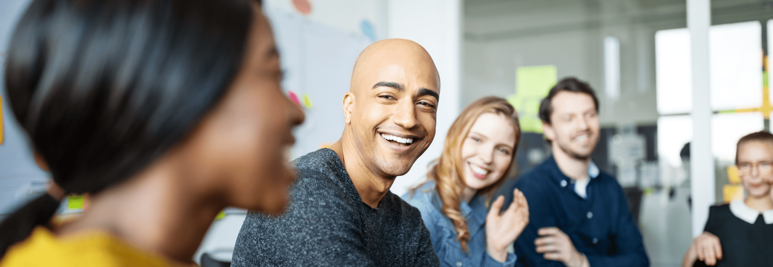 Colleagues in a meeting laughing