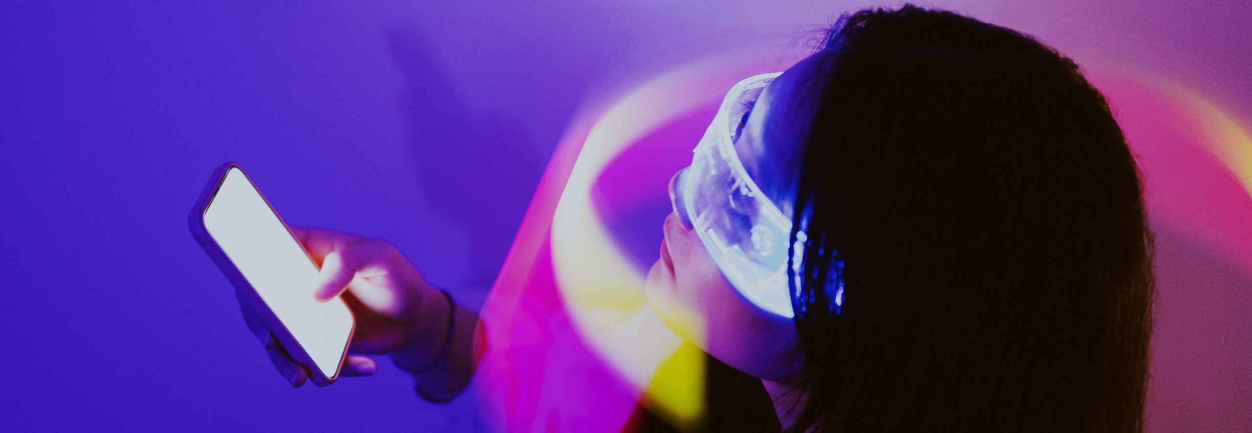 A woman in VR glasses holding a phone