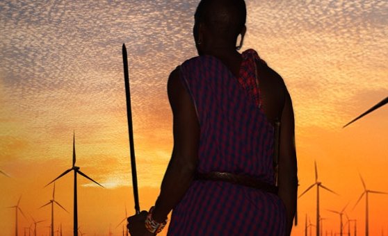 Maasai warrior standing amid power windmills