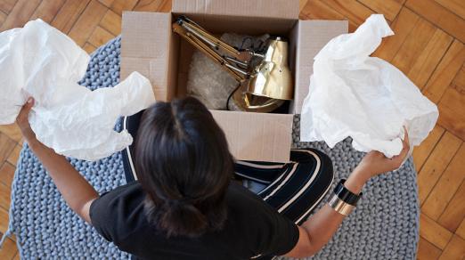 picture of woman opening box with lamp inside