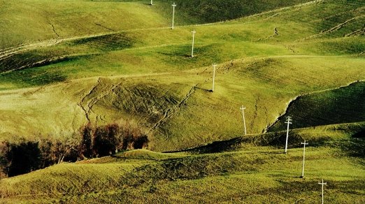 picture of rolling green hills and electrical lines