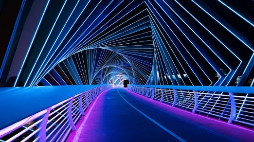 picture of bridge pathway at night with purple and blue lights