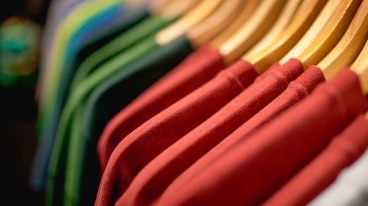 image of clothes on hangers in retail store