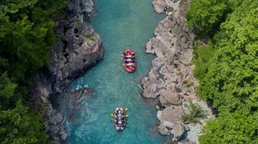 aerial shot of people rafting down a river